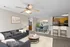 Inviting open-concept living room with cozy seating, elegant dining area, and modern kitchen featuring hardwood cabinetry and stainless steel appliances.