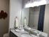 Chic bathroom featuring granite countertops, elegant decor, and bright lighting for a luxurious feel.