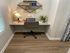 Cozy home office nook with a sleek chair, modern desk, and stylish shelving, perfect for productive work-from-home days.