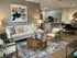 Inviting modern living room with cozy seating, stylish decor, and an open kitchen layout in a welcoming apartment setting.
