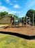 Bright and inviting playground with slides and climbing structures surrounded by lush greenery, perfect for outdoor fun and family enjoyment.
