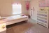 Charming children's bedroom with pastel-themed decor, featuring a cozy bed, colorful dresser, and playful wall art.