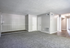 Spacious modern apartment interior with plush carpet and bright natural lighting, offering a clean and versatile living area.