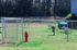 Charming fenced-in dog park area with agility equipment and vibrant green space, ideal for pet-friendly living.