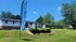 Inviting leasing office with manicured lawn and vibrant welcome sign, perfect for potential tenants at Cielo Apartments.