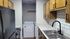 Chic kitchen featuring modern appliances, sleek countertops, and convenient in-unit washer and dryer.
