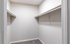 Spacious walk-in closet with double hanging rods, perfect for ample storage and organization.