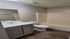 Modern bathroom featuring sleek vanity, pristine sink, and elegant bathtub with stylish wood flooring.
