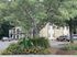 Tranquil apartment setting with lush greenery and vibrant flowerbeds offering a serene living environment.