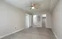 Bright, spacious room with contemporary wood flooring, ceiling fan, and convenient access to bathroom and closet.