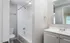 Bright modern bathroom with a sleek vanity, classic white fixtures, and inviting natural light.
