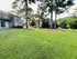 Charming apartment complex nestled among lush greenery and tall trees, offering serene outdoor spaces for relaxation.