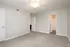 Bright and airy bedroom with plush carpeting, neutral walls, and a ceiling fan, offering a cozy and welcoming atmosphere.