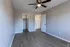 Bright and spacious bedroom with modern wood flooring, ceiling fan, and ample closet space.