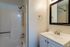 Modern bathroom with sleek fixtures, elegant vanity, and a refreshing shower, offering a serene and inviting atmosphere.