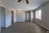 Bright and spacious living area with modern flooring and large windows, perfect for a welcoming home atmosphere.