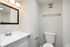 Modern bathroom with elegant vanity, large mirror, and clean white fixtures for a refreshing atmosphere.