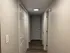 Inviting hallway with elegant white doors and modern overhead lighting, featuring sleek wooden flooring for a stylish entrance.