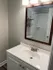 Modern bathroom featuring a sleek vanity with ample storage and elegant lighting, inviting a sense of tranquility and style.