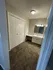 Inviting carpeted hallway with modern vanity and ample closet space, perfect for stylish living.