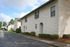 Charming apartment complex with pristine brick exterior, well-maintained landscaping, and convenient parking area.