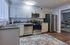 Modern kitchen with stainless steel appliances, elegant cabinetry, and a cozy, open layout ideal for culinary delights.