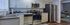 Modern kitchen with sleek stainless steel appliances, stylish cabinetry, and a cozy adjoining living room, perfect for entertaining.