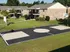 Charming apartment complex with brick exterior, featuring lush green lawns and a vibrant basketball court for outdoor recreation.