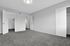 Bright and spacious bedroom featuring plush carpet, multiple doorways, and neutral walls, offering a versatile living space.