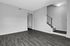 Charming apartment interior with sleek hardwood floors and cozy carpeted staircase, perfect for modern living.