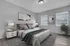 Modern bedroom featuring a plush bed, stylish decor, and natural light from two large windows. Elegant nightstands with chic lamps accentuate the serene ambiance.