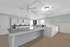 Spacious laundry room with modern washers and dryers, featuring ample folding space and sleek design.
