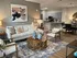 Inviting open-concept living room with stylish decor, contemporary furniture, and a cozy atmosphere leading to a modern kitchen.