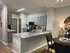 Chic open-concept kitchen with modern appliances and elegant granite countertops, adjacent to a stylish dining area.