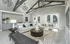Luxury living room featuring stylish geometric lighting, elegant decor, and poolside view through glass doors.