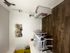 Charming dining corner with elegant wooden flooring, adorned with tasteful art and fresh flowers.
