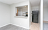 Inviting open-concept kitchen with sleek countertops and modern appliances, adjacent to a cozy living area with elegant flooring.