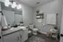 Elegant bathroom with modern vanity, plush towels, and stylish decor accentuated by soothing neutral tones.