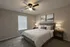 Inviting bedroom with modern design features a cozy bed, elegant bedside lamps, and serene artwork in a bright space.