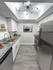 Modern kitchen with sleek stainless steel appliances, granite countertops, and ambient lighting.