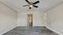 Elegant apartment interior with sleek hardwood flooring and a modern ceiling fan, inviting a cozy living ambiance.