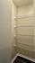 Spacious walk-in closet with sleek wire shelving, perfect for organized storage and modern living.