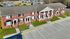 Charming red brick apartment complex with classic architecture, inviting front porches, and ample parking space.