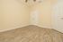 Bright empty room featuring elegant wood flooring, light cream walls, and ample closet space, perfect for personalization.
