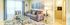 Inviting living room with cozy gray sofa, stylish glass coffee table, and soft plush rug, featuring modern decor and inspirational wall art.