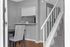 Charming interior with cozy dining area, modern staircase, and sleek breakfast bar, perfect for stylish living.
