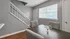 Charming dining area with elegant gray walls, a stylish glass centerpiece, and inviting natural light from large windows.