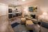 Modern apartment living room with chic open kitchen, stylish decor, cozy seating, and warm lighting.