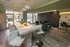 Modern lounge area with sleek marble countertop, stylish seating, and floor-to-ceiling windows offering a bright, inviting space.