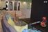Modern lobby area featuring vibrant decor, including colorful cushions, sleek furniture, and artistic wall mirrors.